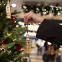 Someone decorates a Christmas tree