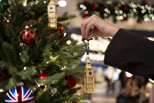 Someone decorates a Christmas tree