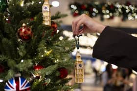Someone decorates a Christmas tree