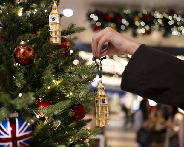 Someone decorates a Christmas tree