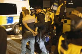 A person is led away by police during a protest in Gosport, Hampshire (Trevor Adams/PA)