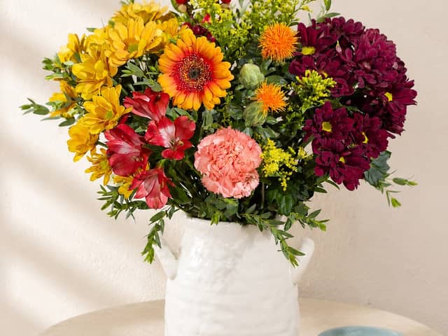 Bunches’ Autumn Sunrise bouquet combines warm yellow, orange, red and burgundy blooms for a colourful seasonal display.