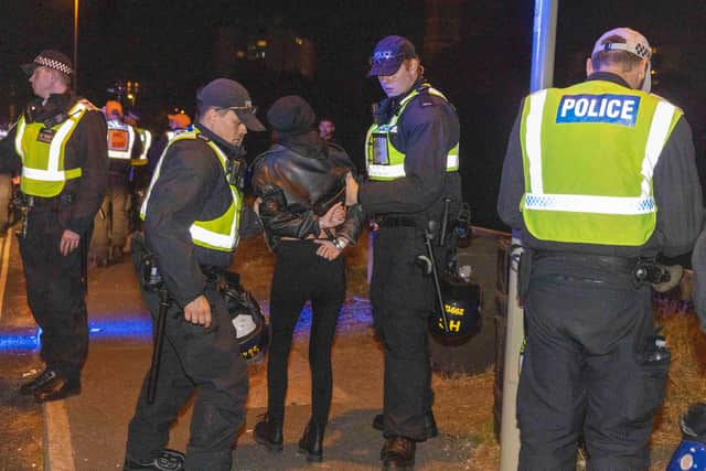 A person is led away by police during a protest in Gosport, after police closed off the access road to Haslar Marina, after British rescue boats have been sent to collect the passengers of a migrant dinghy which has spent around 30 hours at sea. Photo: Trevor Adams/PA Wire
