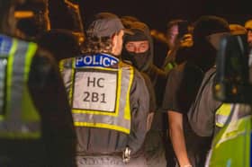 Police and protesters in Gosport after police closed off the access road to Haslar Marina, after British rescue boats have been sent to collect the passengers of a migrant dinghy which has spent around 30 hours at sea. Picture date: Tuesday September 22, 2026. PA Photo. Photo credit should read: Trevor Adams/PA Wire