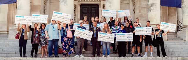Cheques presented by the Victorious in the Community team
