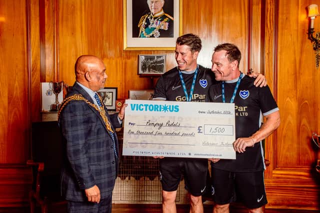 Pompey Pedals receives a cheque from Victorious, presented by Councillor Abdul Kadir