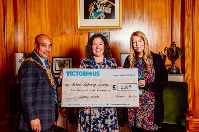 School Library Service receives a cheque from Victorious Festival, presented by Councillor Abdul Kadir