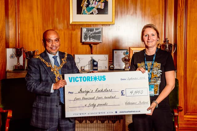 Amy O’Shaughnessy, co-founder of George’s Rockstars accepts a cheque from Victorious, presented by Lord Mayor Councillor Abdul Kadir