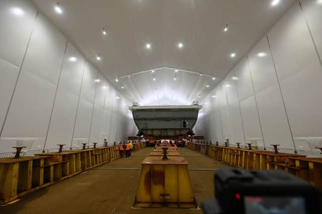 The block of HMS Sheffield being prepared to receive her paint job in the new facility.