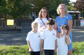 Toni Harris and Tamsin De La Haye with Arthur 7, Teddy 6 and George 6 outside Moorings Way Infant School, Southsea