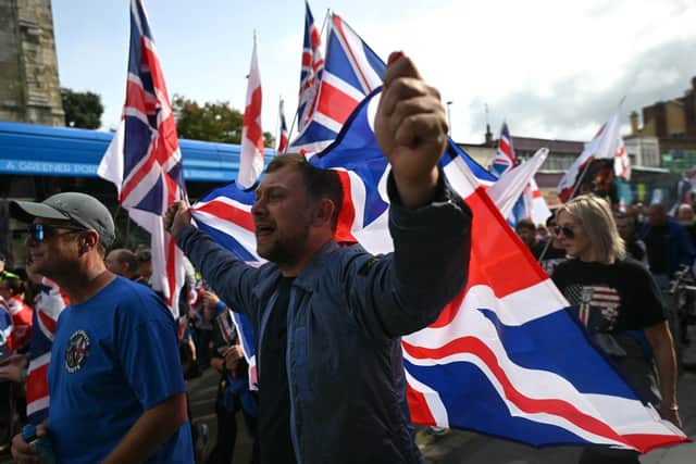 A demonstrator carries a Union Jack flag during a march organised by a group called the South Coast Patriots, in Southampton