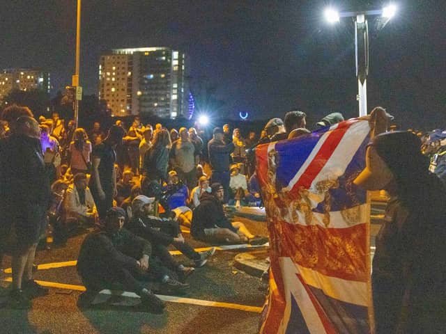 Demonstrators during an anti-migrant protest in Gosport, Authorities are preparing for the arrival of a migrant dinghy heading for the south coast. The dinghy is being shadowed by French coastguard and rescue vessels, and is moving towards the Channel boundary line, according to ship tracking data. Picture date: Sunday October 4, 2026. PA Photo. Photo credit should read: Trevor Adams/PA Wire