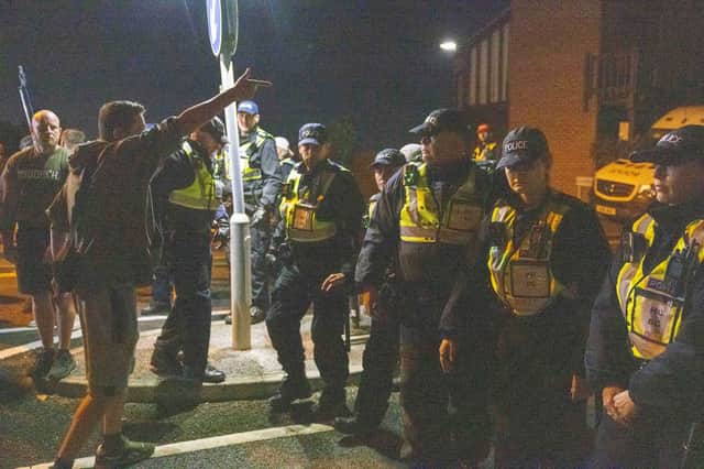 Police and demonstrators during an anti-migrant protest in Gosport on October 4, 2026