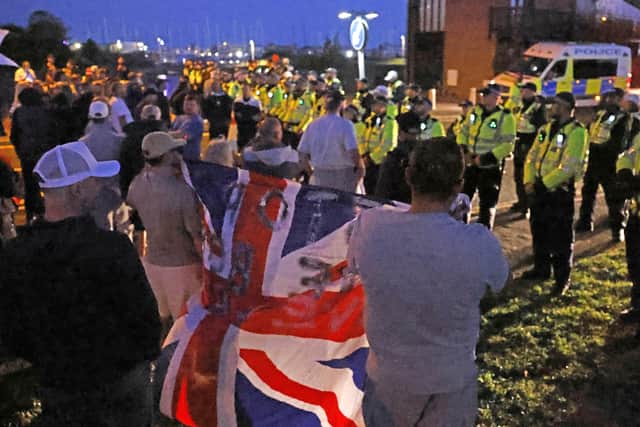 Police and demonstrators during a protest in Gosport when the migrants were brought ashore in the town