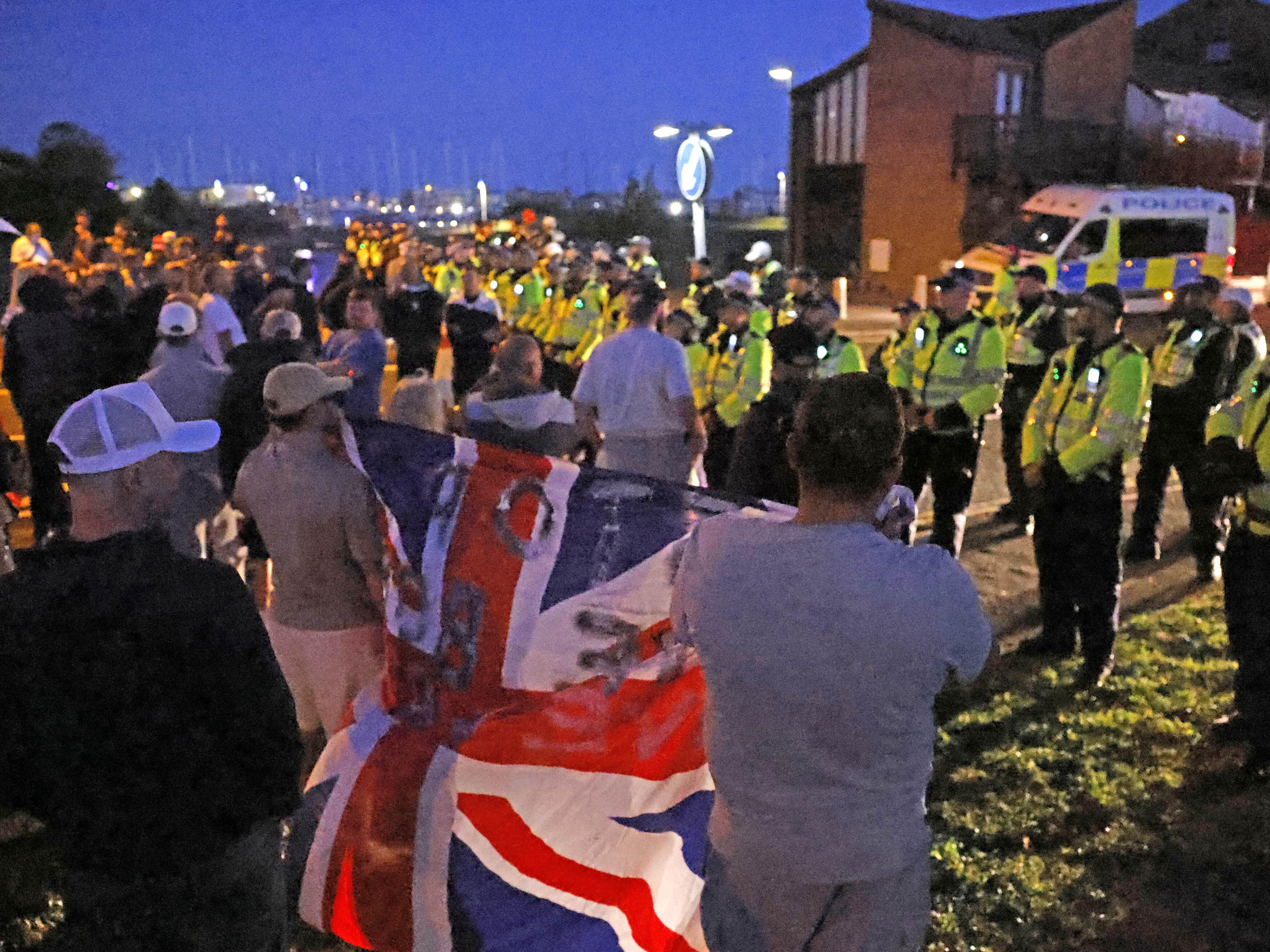12 arrested over public order incident that left police injured as migrants brought into Gosport