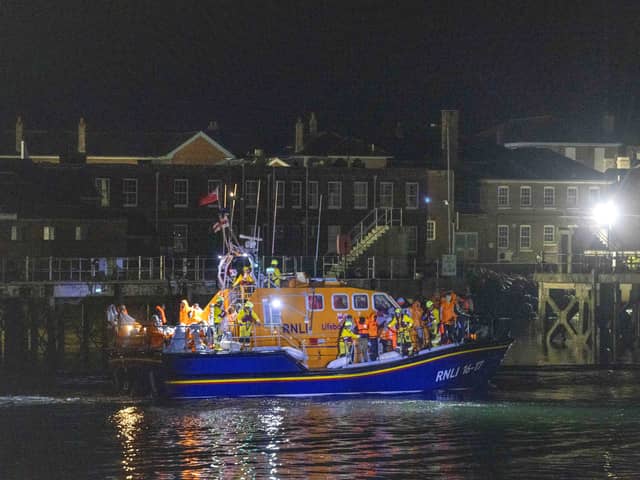 A group of people thought to be migrants are brought in to a marina in Gosport, by the RNLI following a small boat incident in the Channel
