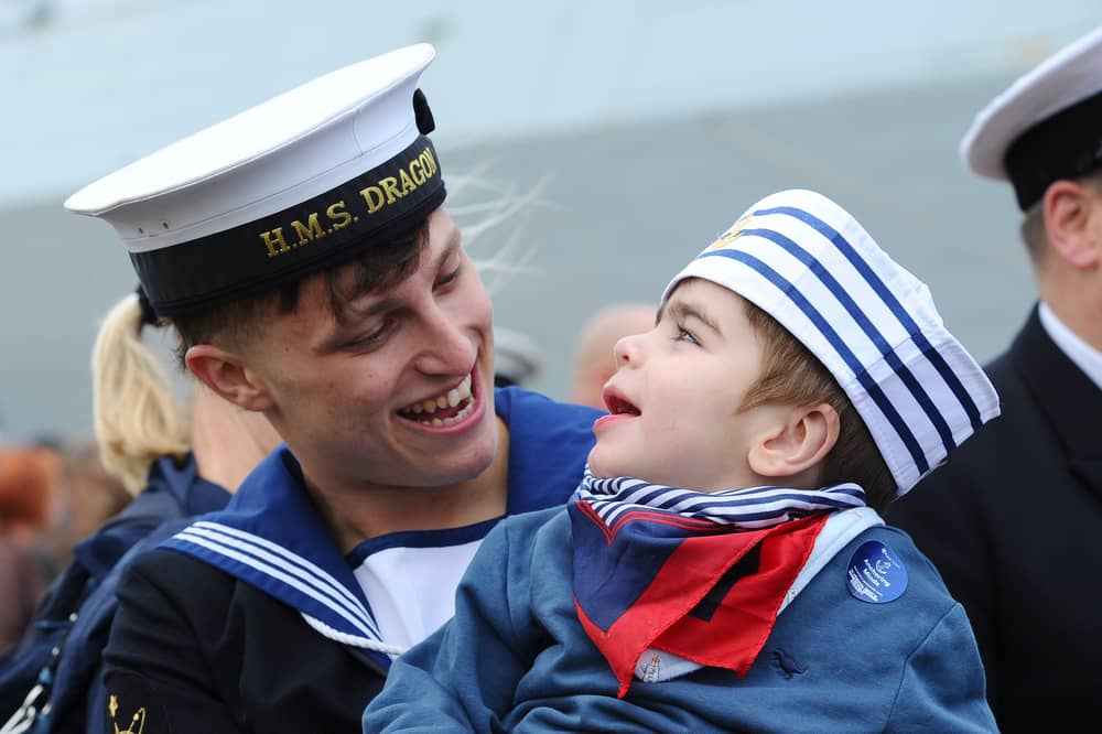 HMS Dragon homecoming on October 9, 2026. Pictured is: Leading Hand Charlie Gill from Littlehampton, West Sussex, with his cousin Finlay Ratan (2). Charlie donated part of his liver to Finlay when he was just four-months-old after needing a transplant.