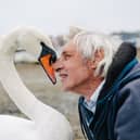 Gordon Chandler with a swan a Emsworth Harbour.