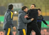Pompey boss John Mousinho and Wolves head coach Cesar Peixoto collide. Pic: PA
