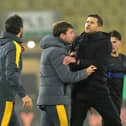 Pompey boss John Mousinho and Wolves head coach Cesar Peixoto collide. Pic: PA