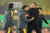 Pompey boss John Mousinho and Wolves head coach Cesar Peixoto collide. Pic: PA