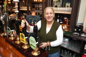 Landlady Ally Wearn pouring a pint on Tuesday, October20.

