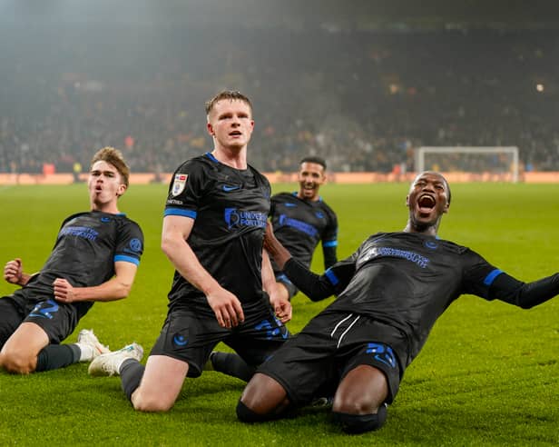 Goalscorer Terry Devlin, centre, with Eoin Kenny, Odin Bailey and Jojo Dia celebrate Pompey's equaliser at Wolves in front of the away end at Molineux.