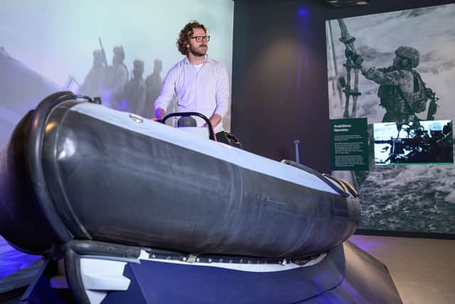 JJ Chalmers, presenter and former Royal Marine, trying out the rib inside the Royal Marines Experience at Portsmouth Historic Dockyard ahead of its public opening on Saturday. Veterans praised the new attraction.