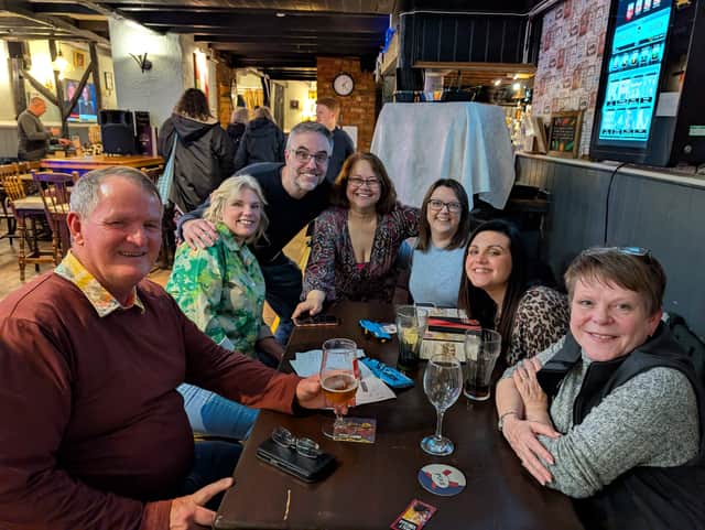 Quiz master Gary Parker with Home Instead team - runners up at the last charity quiz