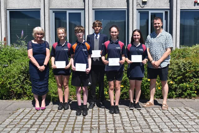 Proud students receive their awards from Headteacher Julie Summerfield and History Teacher Mr Harrison-Jeal this summer.