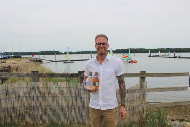 Sean Murphy, Venue Operations Manager at Boathouse Chichester, with bottles of Tidal Rum ahead of the Tidal Rum Takeover this August Bank Holiday Sunday.