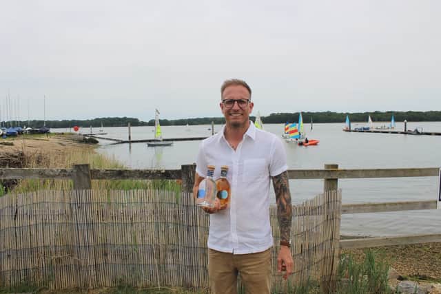 Sean Murphy, Venue Operations Manager at Boathouse Chichester, with bottles of Tidal Rum ahead of the Tidal Rum Takeover this August Bank Holiday Sunday.