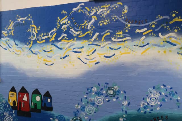 One side of the mural which portrays the school's house colours