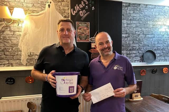 Abby's Heroes with money raised from charity quiz