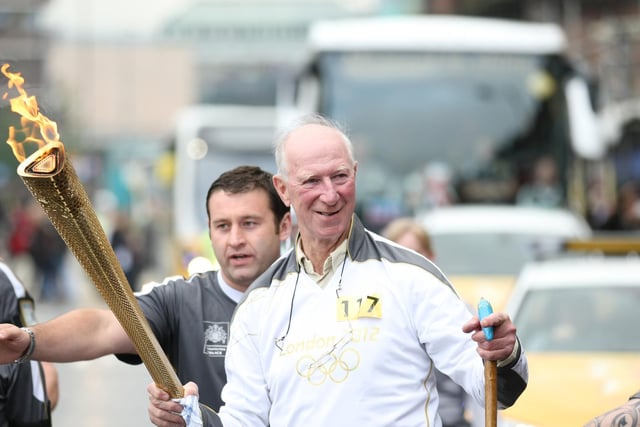 Torchbearer Jack Charlton carries the Olympic Flame through Newcastle upon Tyne in June 2012. Picture by Chris Radburn/LOCOG/Press Association.