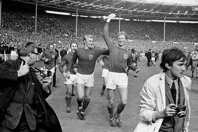 Charlton holds the Jules Rimet trophy aloft as he parades it around Wembley after England's 4-2 victory against West Germany in the 1966 World Cup final. Picture by PA.