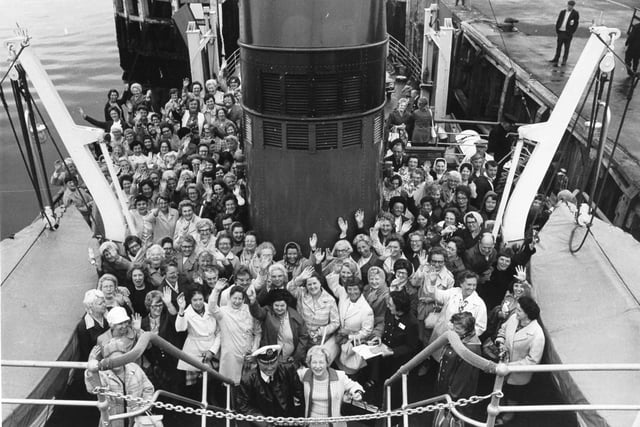 Happy smiles and waves from Women's Circle members on the ferry as they leave Gourock for the trip across to Dunoon. Pictured (centre foreground) is Orrall Hewison with Captain Duncan Munro of the Maid of Cumbrae ferry.