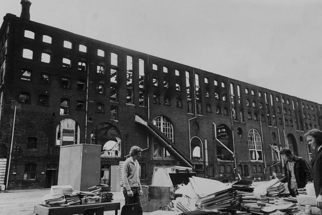 This is all that remains of the office effects from a fire which gutted warehouse in Marsh Lane. The men are employees of National Carriers Ltd., who had an office in the building.