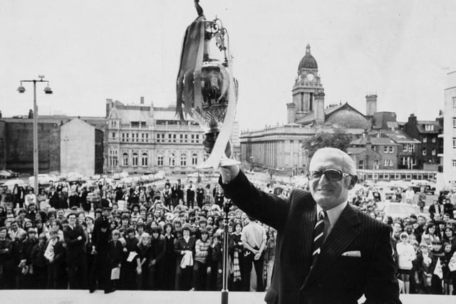 Leeds United chairman Manny Cussins displays the League Championship Trophy outside the Civic Hall during the reception for the team.