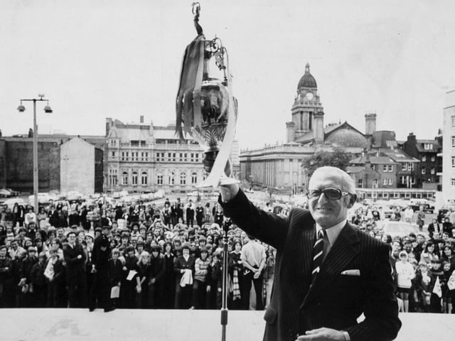 Leeds United chairman Manny Cussins displays the League Championship Trophy outside the Civic Hall during the reception for the team.