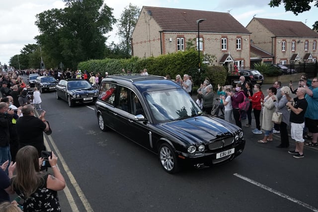 Well-wishers threw flowers on the hearse as it passed slowly through the former mining community where he and his younger brother Sir Bobby honed their football skills.