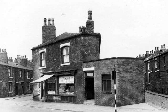 On the left is East Beckett Street. Number 98 Accommodation Road is a fresh fish shop. To the right is a bakers shop.
