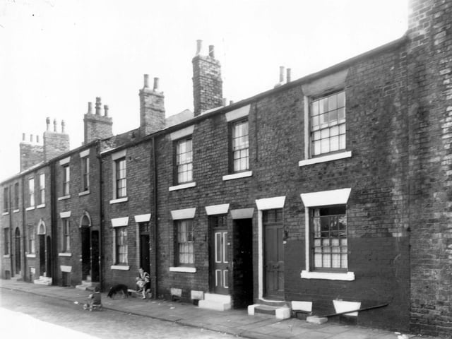 Arthur Street in July 1960. A woman is in the doorway of number 14.