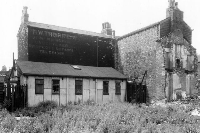June 1960. An area of waste ground, looking towards the rear of Coleridge Street. A faded sign on the wall advertised H.W. Thorpe, joiner and builder. This was looking from Stoney Rock Lane.
