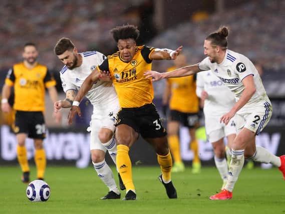 Whites duo Mateusz Klich, left, and Luke Ayling, right, get to grips with Wolves powerhouse Adama Traore. Photo by Alex Pantling/Getty Images.