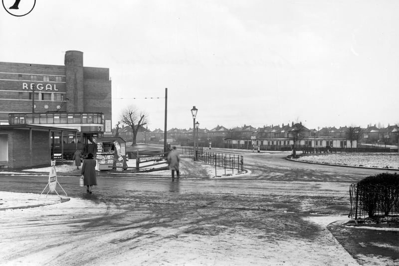 The roundabout looking onto Cross Gates Ring Road and showing the Regal cinema in January 1956. A small newsagents kiosk with a road sign is to the right.
