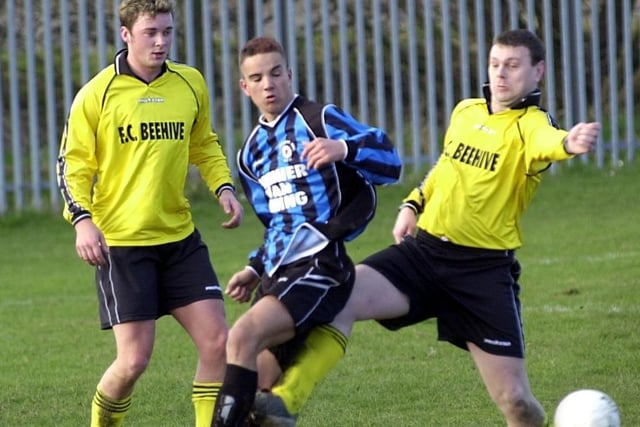 Daniel Lowe, centre of Alverthorpe under pressure flicks the ball on against Beehive.