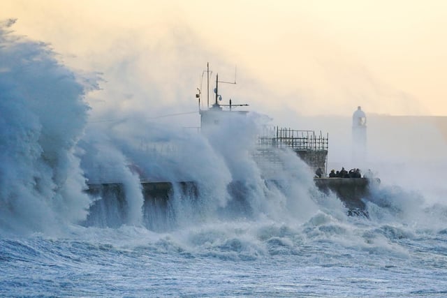 A striking image of waves crashing against Porthcawl Lighthouse in Porthcawl, Bridgend, Wales