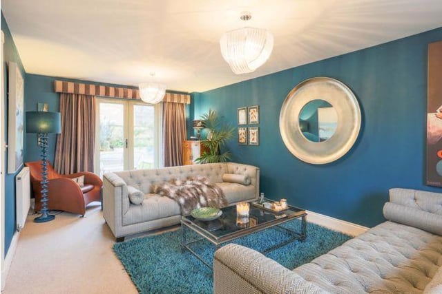 The spacious lounge is very elegant. It is a great size for relaxing with the family. The current owners have painted it a striking blue, with lots of texture to create a cosy space.