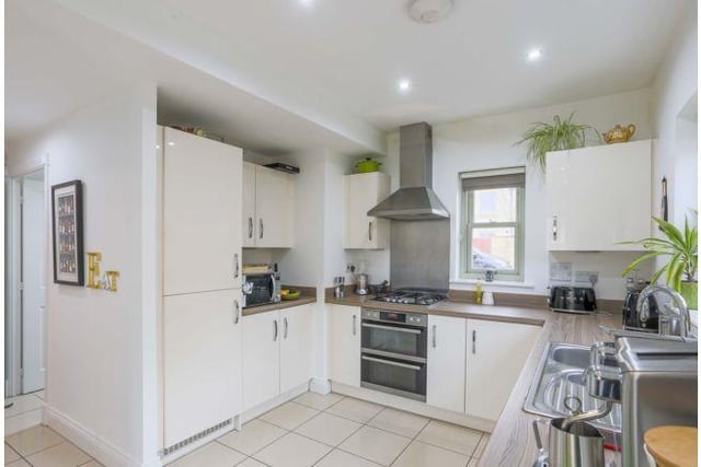 The open plan kitchen diner which has a full range of fitted appliances and double doors leading out into the garden. It benefits from a separate utility room.